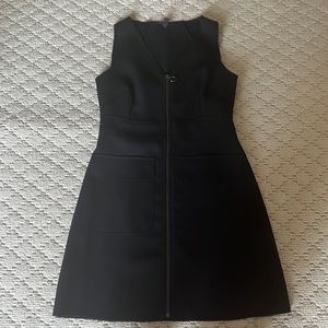 Black, structured dress with a zip from top to bottom. Form fitting. Size 6